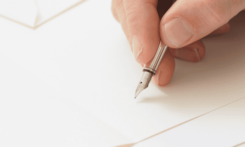 A hand writing on a paper